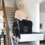 elderly man in a wheel chair riding a lift