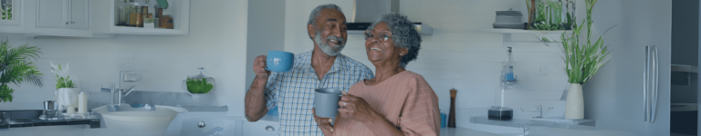 happy couple in their kitchen with emergency call systems to help ensure safety