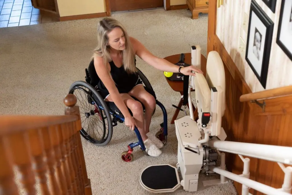 Disabled woman getting on a stair lift.