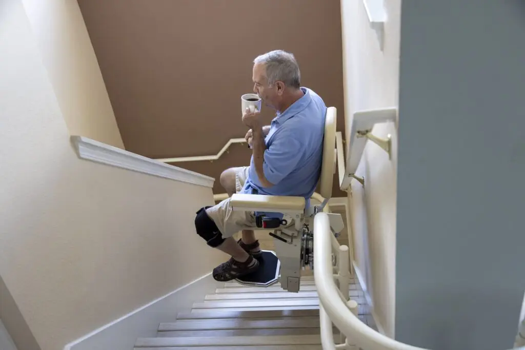 Stair lift descending down stairs.