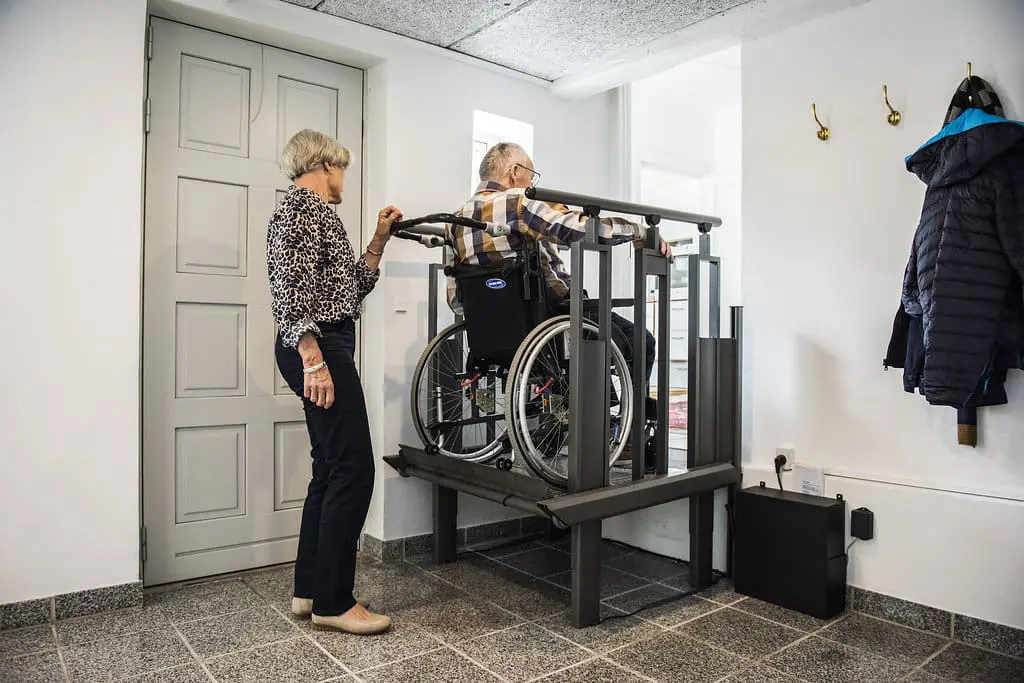 Elderly couple using a home platform lift