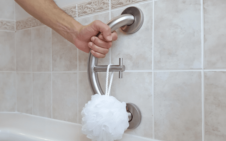 Accessible bathroom with grab bars, shower seating, and a low-threshold shower