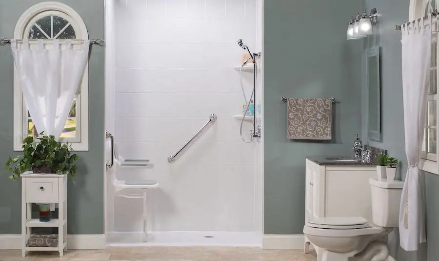 Barrier-free shower with grab bars, handheld showerhead, and slip-resistant flooring