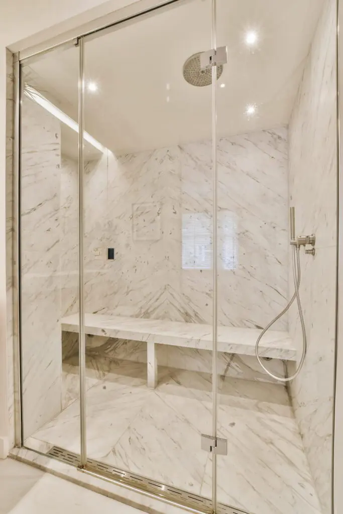 Elegant Marble Shower with Glass Door and Bench