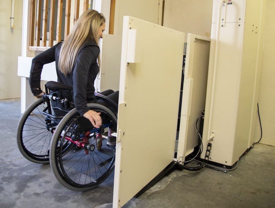 woman in a wheelchair on a vertical platform lift installed in her home